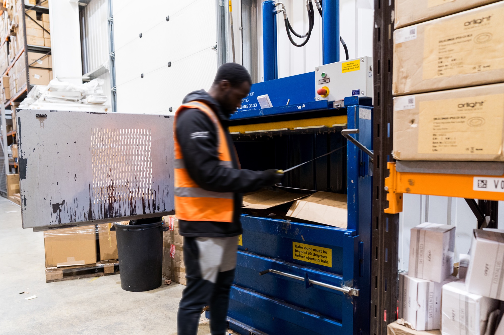 Packaging cardboard being baled for recycling in the Orlight warehouse